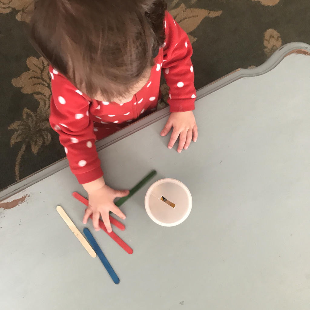 Sticks in a Can Baby Game for Problem Solving and Coordination.